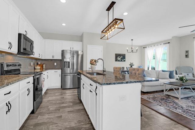 101 Patterson Ave, Goose Creek, SC 29445 - kitchen featuring appliances with stainless steel finishes, a chandelier, dark stone counters, decorative backsplash, and recessed lighting