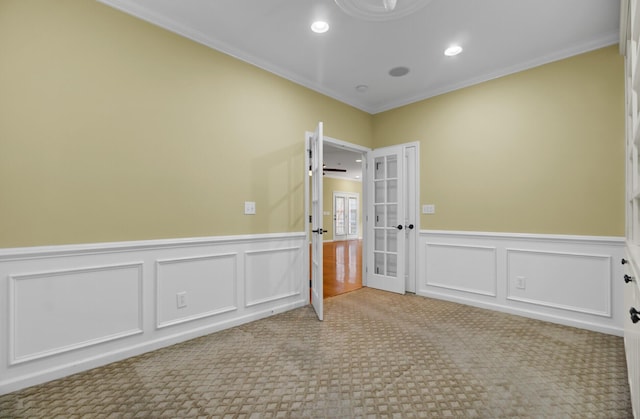 empty room featuring ornamental molding and french doors