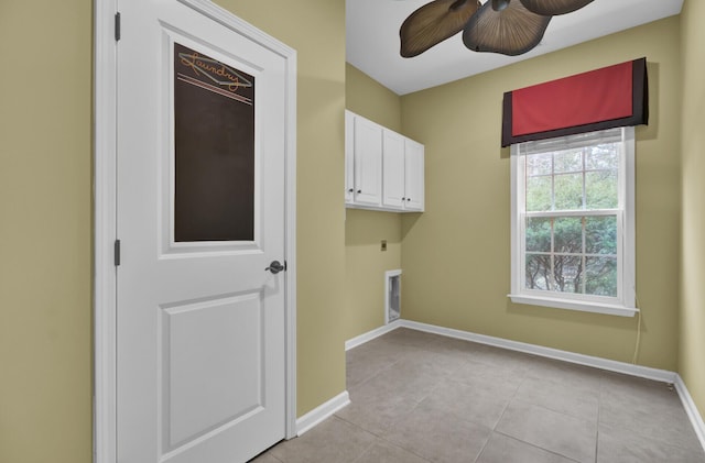 washroom featuring ceiling fan, light tile patterned floors, electric dryer hookup, and cabinets