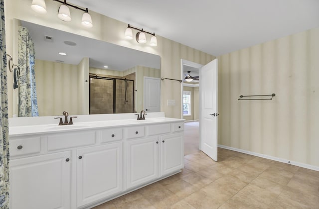 bathroom with vanity and a shower with door