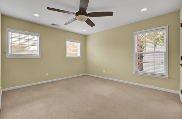 unfurnished room with ceiling fan and light colored carpet