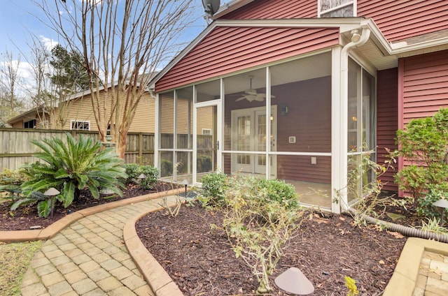 back of house with ceiling fan and a sunroom