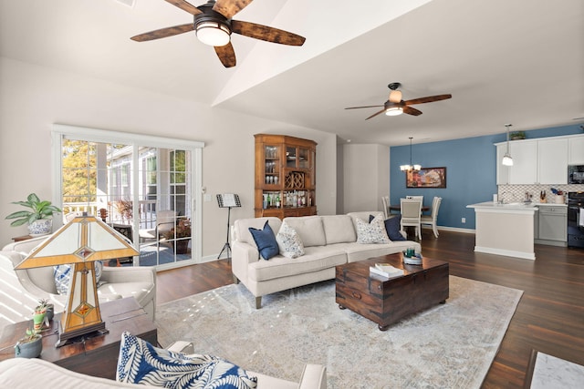 living room featuring dark hardwood / wood-style floors and ceiling fan with notable chandelier