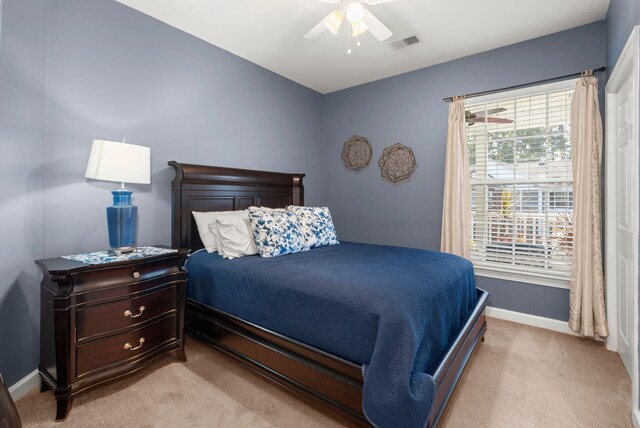 bedroom with light colored carpet and ceiling fan