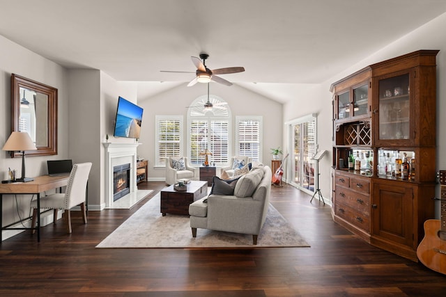 living room with lofted ceiling, ceiling fan, and dark hardwood / wood-style flooring