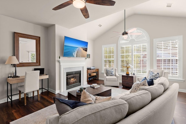 living room featuring dark hardwood / wood-style flooring, ceiling fan, and vaulted ceiling