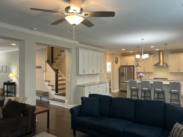 living area featuring ornamental molding, recessed lighting, dark wood-type flooring, and stairs