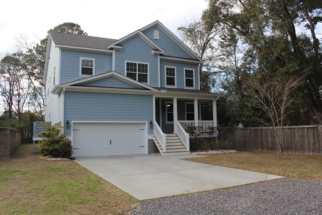 traditional home featuring roof with shingles, covered porch, fence, a garage, and driveway