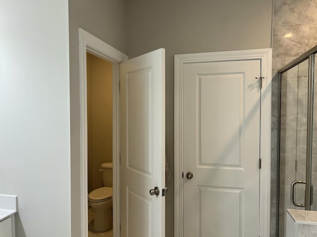 full bathroom with toilet and a stall shower