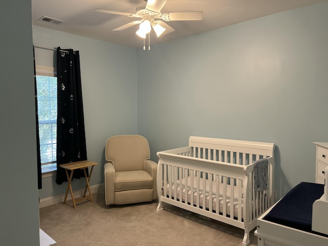 bedroom with baseboards, ceiling fan, visible vents, and light colored carpet