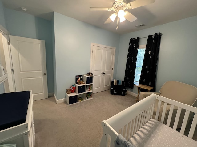 carpeted bedroom featuring baseboards, visible vents, and ceiling fan