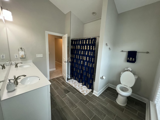 bathroom featuring wood finish floors, baseboards, a sink, and curtained shower