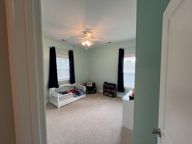 carpeted bedroom with baseboards, multiple windows, and visible vents