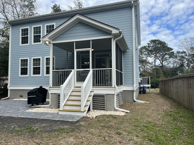 back of house with a sunroom, fence, and crawl space