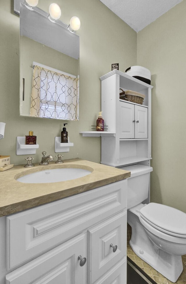 bathroom featuring toilet and vanity