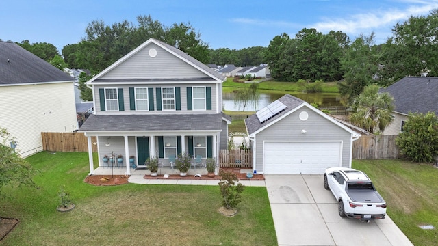 view of front facade featuring a garage, covered porch, an outdoor structure, and a front yard