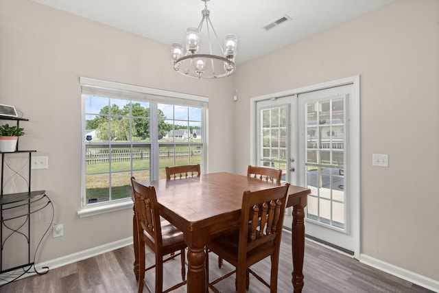 dining space featuring a chandelier, french doors, and dark hardwood / wood-style flooring