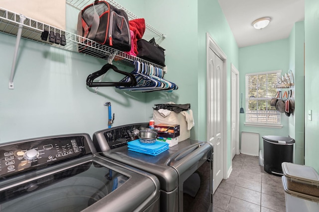 washroom with light tile patterned floors and washing machine and clothes dryer