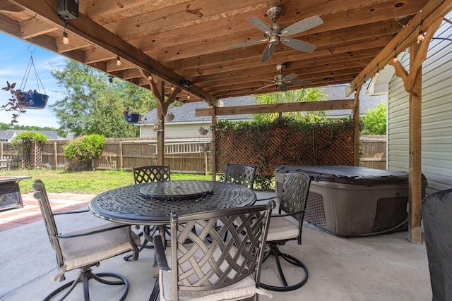 view of patio featuring ceiling fan and a hot tub