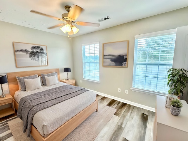 bedroom with ceiling fan and wood-type flooring