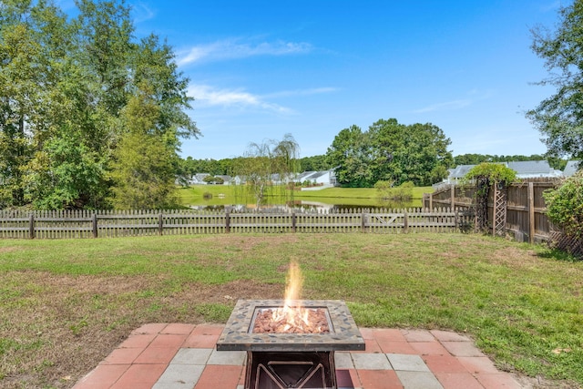 view of yard featuring a fire pit and a patio area