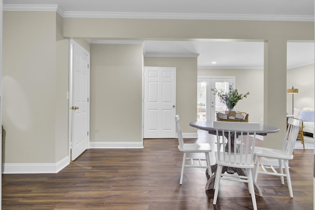 dining space with crown molding, dark hardwood / wood-style floors, and french doors