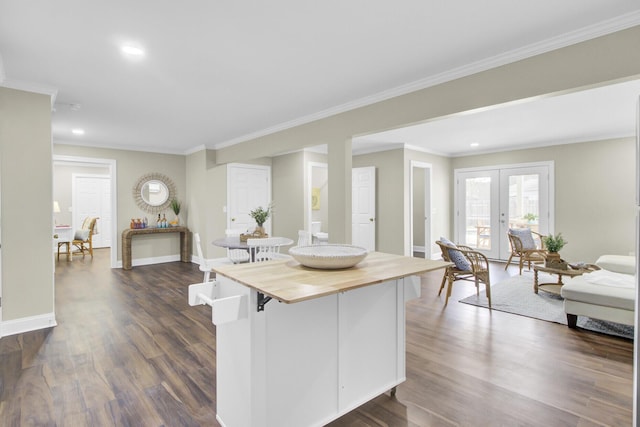 kitchen featuring french doors, ornamental molding, dark hardwood / wood-style floors, and butcher block counters