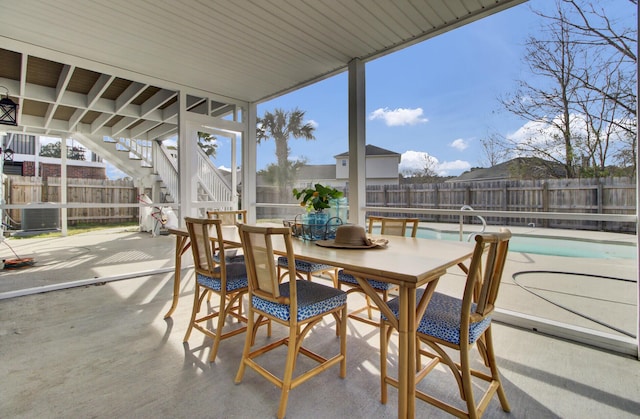 exterior space with a fenced in pool and cooling unit