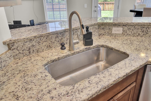 308 Legendres Dr, Goose Creek, SC 29445 - kitchen view of a sink, light stone counters, dishwasher, and brown cabinetry