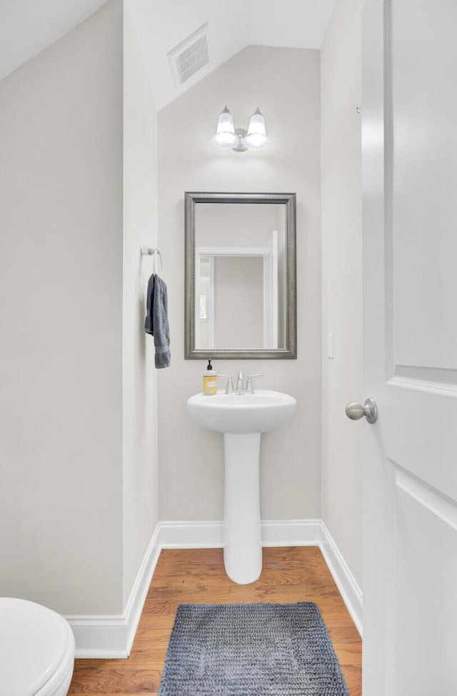 308 Legendres Dr, Goose Creek, SC 29445 - half bathroom with wood finished floors, toilet, baseboards, and vaulted ceiling