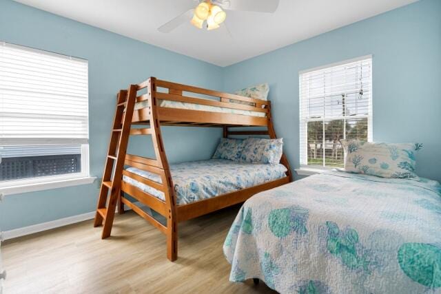 bedroom with wood-type flooring and ceiling fan