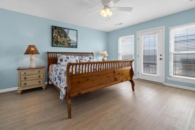 bedroom with wood-type flooring, ceiling fan, and access to exterior