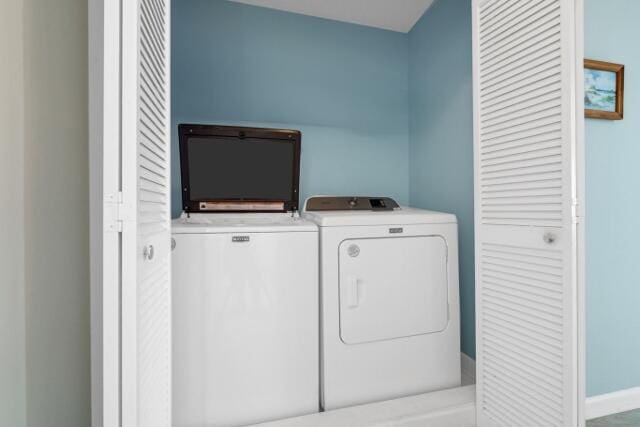 clothes washing area with washing machine and dryer