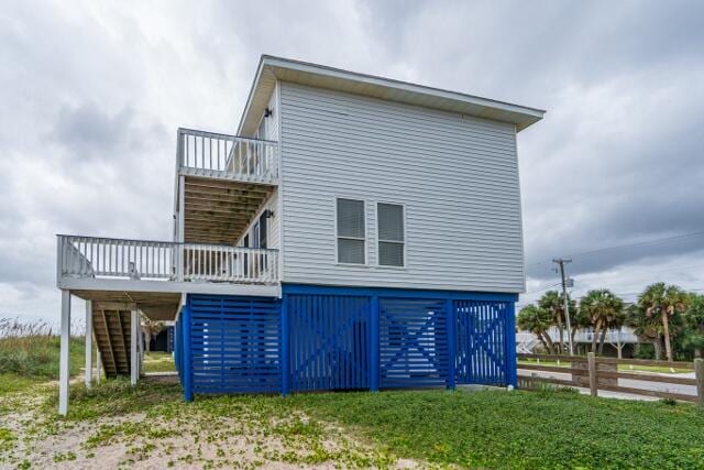 rear view of property with a wooden deck