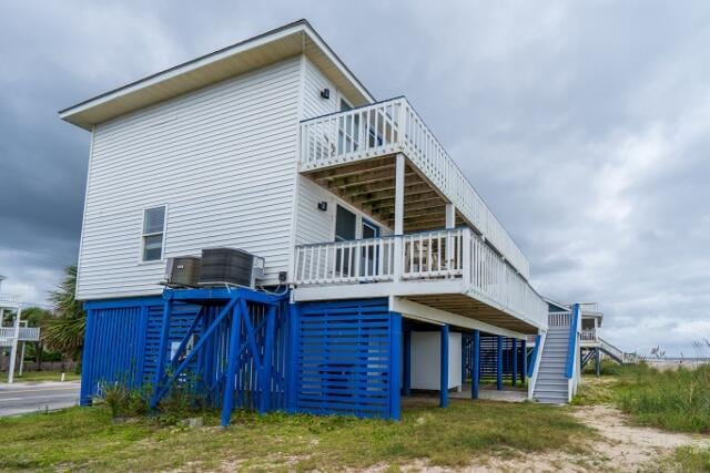 rear view of house featuring a wooden deck