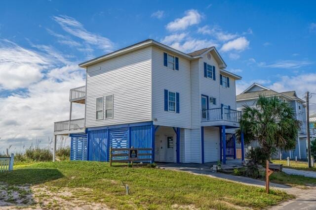 exterior space with a balcony and a front lawn