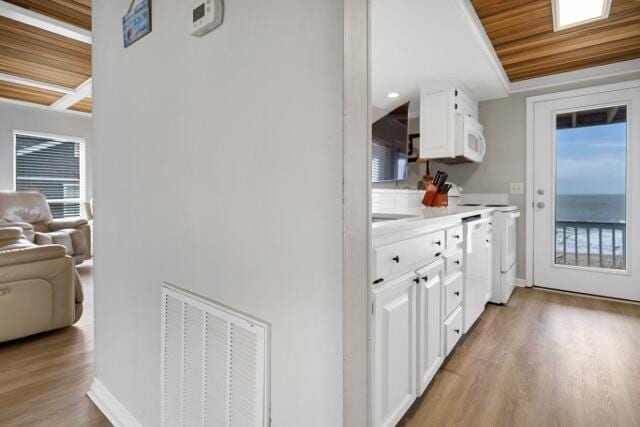 kitchen with wood ceiling, white cabinets, white appliances, and light hardwood / wood-style flooring