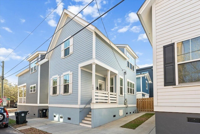 view of side of property featuring crawl space and fence