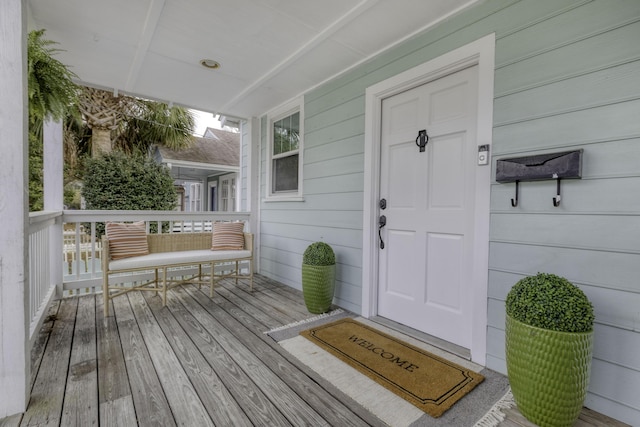 view of exterior entry featuring a porch