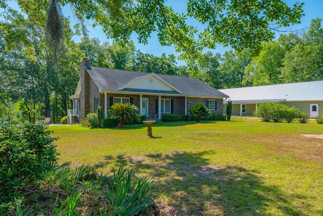 ranch-style house featuring a front lawn and a chimney