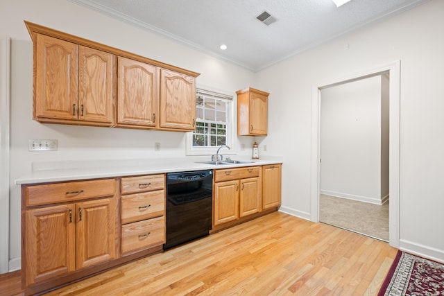 kitchen with visible vents, a sink, ornamental molding, black dishwasher, and light wood-style flooring