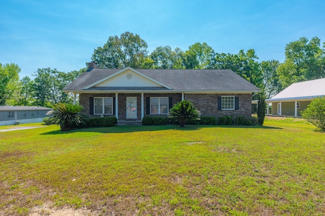 view of front of house featuring a front lawn and brick siding