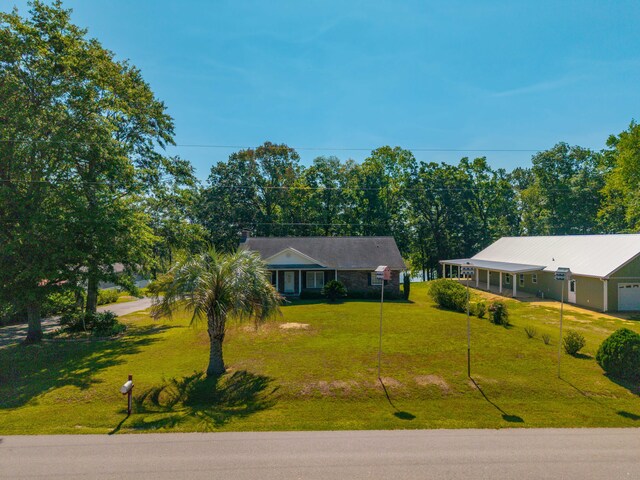 single story home featuring a front yard and a garage