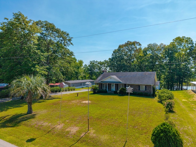 single story home featuring driveway and a front lawn