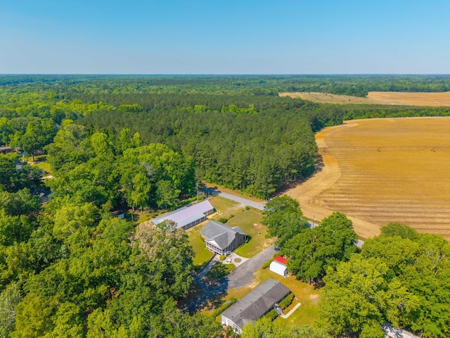 birds eye view of property featuring a view of trees