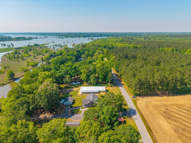 bird's eye view with a water view and a forest view