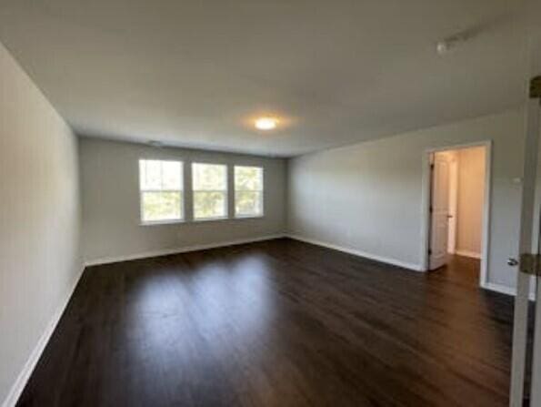 unfurnished room with dark hardwood / wood-style floors