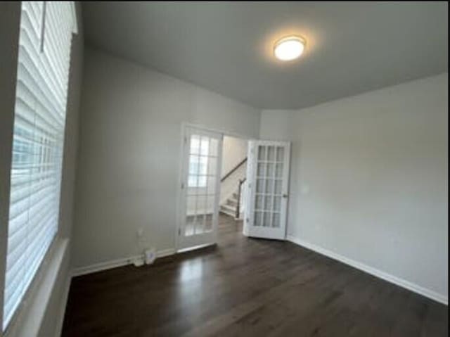 empty room with dark wood-type flooring