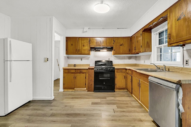 kitchen featuring sink, white fridge, stainless steel dishwasher, a textured ceiling, and black gas range