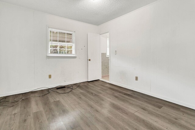 empty room featuring hardwood / wood-style floors and a textured ceiling